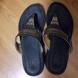 Black and gold sketcher sandals
